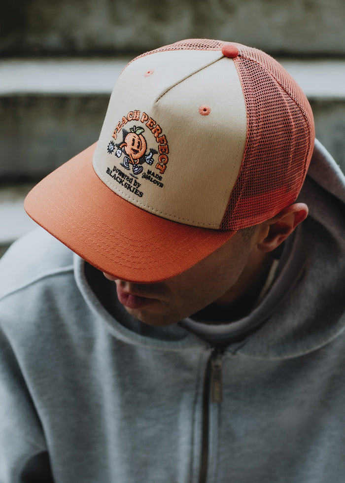 Blackskies-15th-Anniversary-Trucker-Cap-Peach-Model-2